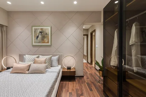 Bedroom in a Mumbai two-bedroom show apartment with a double bed, a fitted wardrobe and a narrow clear walkway beside the bed